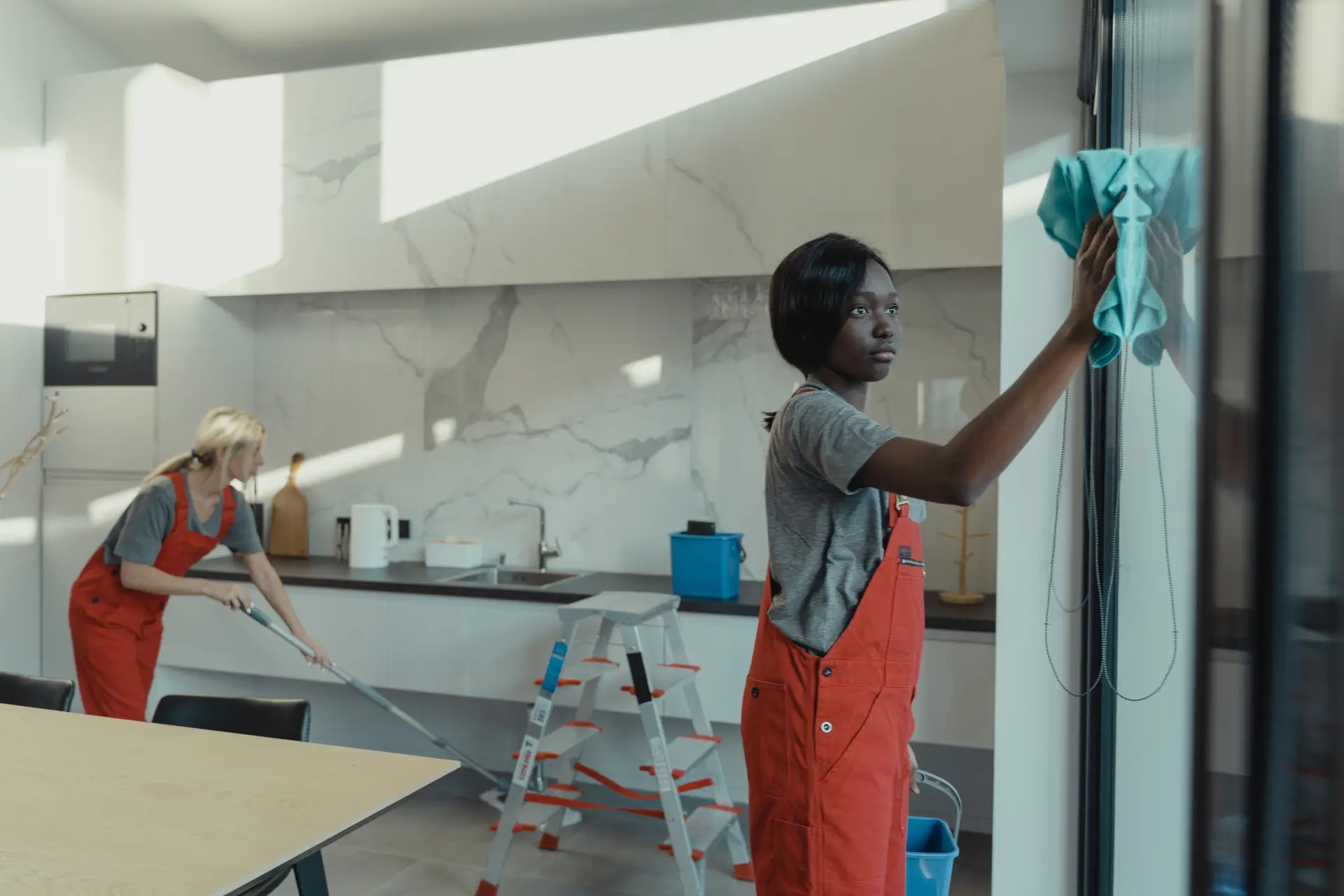 Professional cleaning team working in a modern house